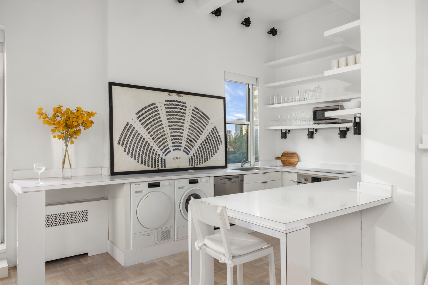 400 East 52nd Street, Unit PHTOWER Manhattan, NY 10022 - Photo 9 of 23 a kitchen with a sink a stove and white cabinets with wooden floor