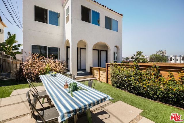 a view of an chairs and tables in the backyard
