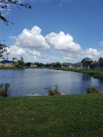 a view of a lake with houses in the back