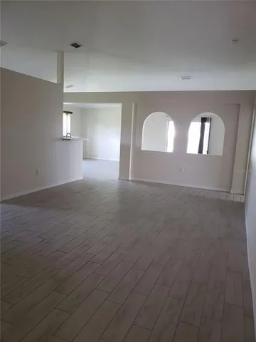 a view of a room with wooden floor and window