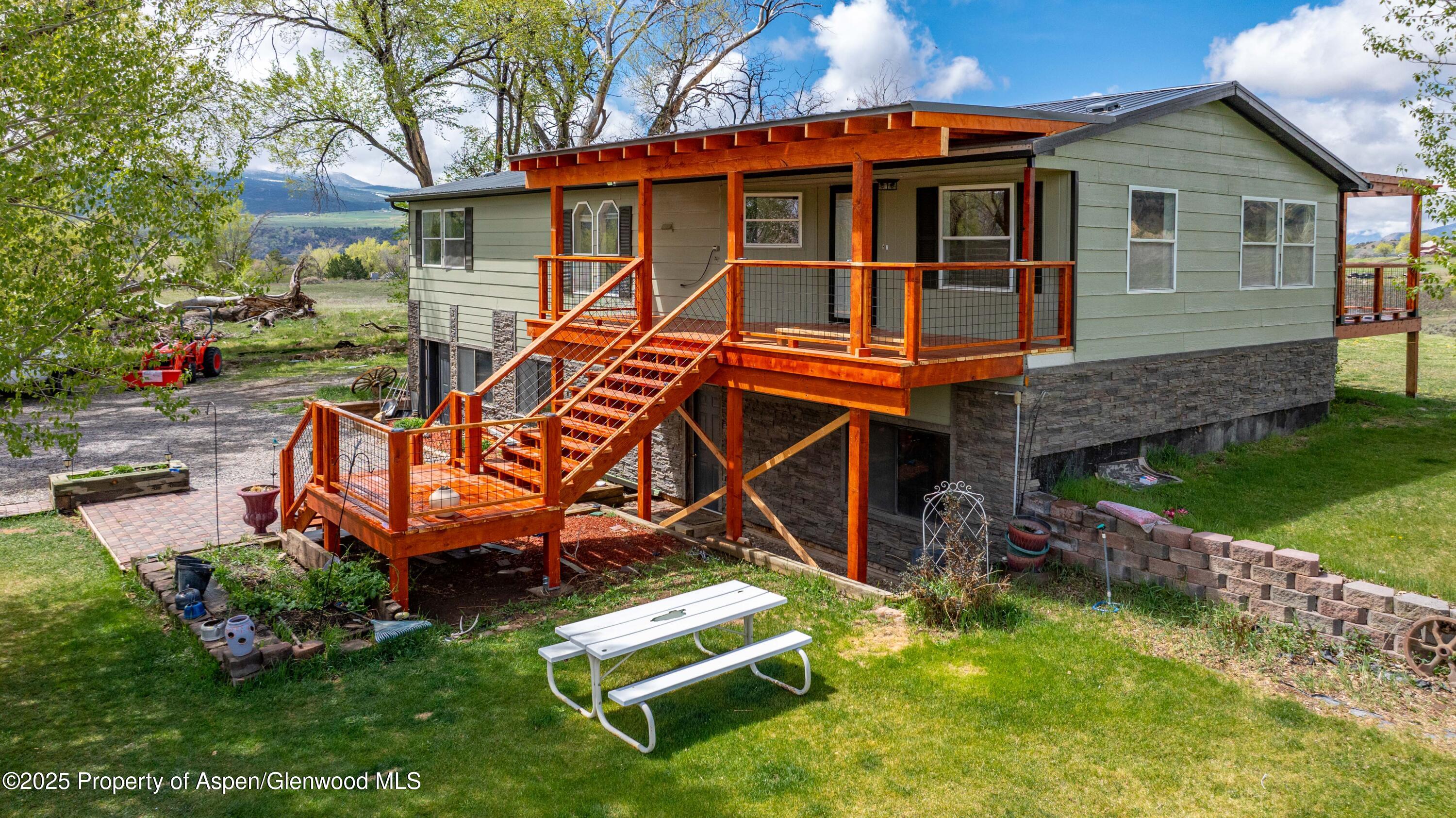 233 County Road 265 Rifle, CO 81650 - Photo 2 of 35 an aerial view of a house with swimming pool and a yard
