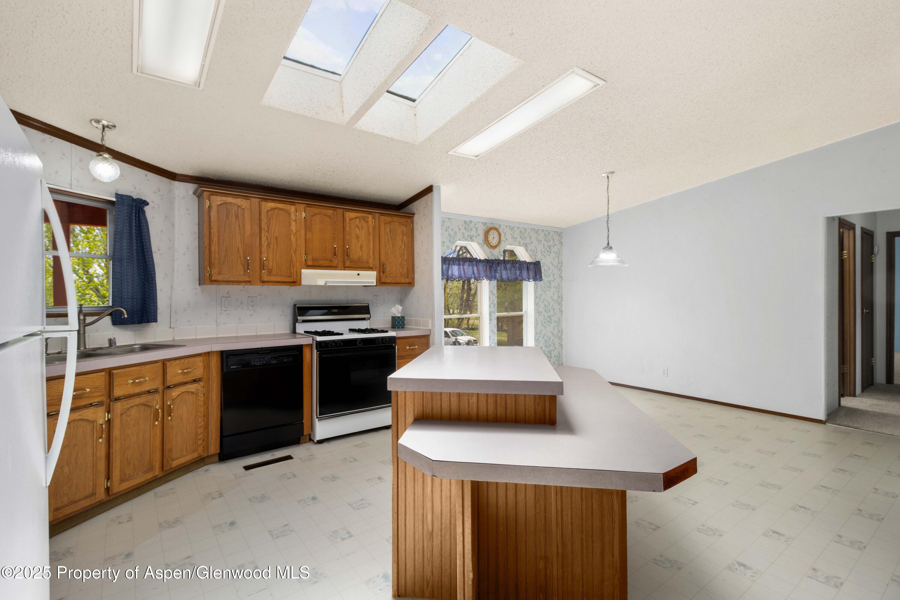233 County Road 265 Rifle, CO 81650 - Photo 21 of 35 a kitchen with stainless steel appliances granite countertop a sink stove and refrigerator