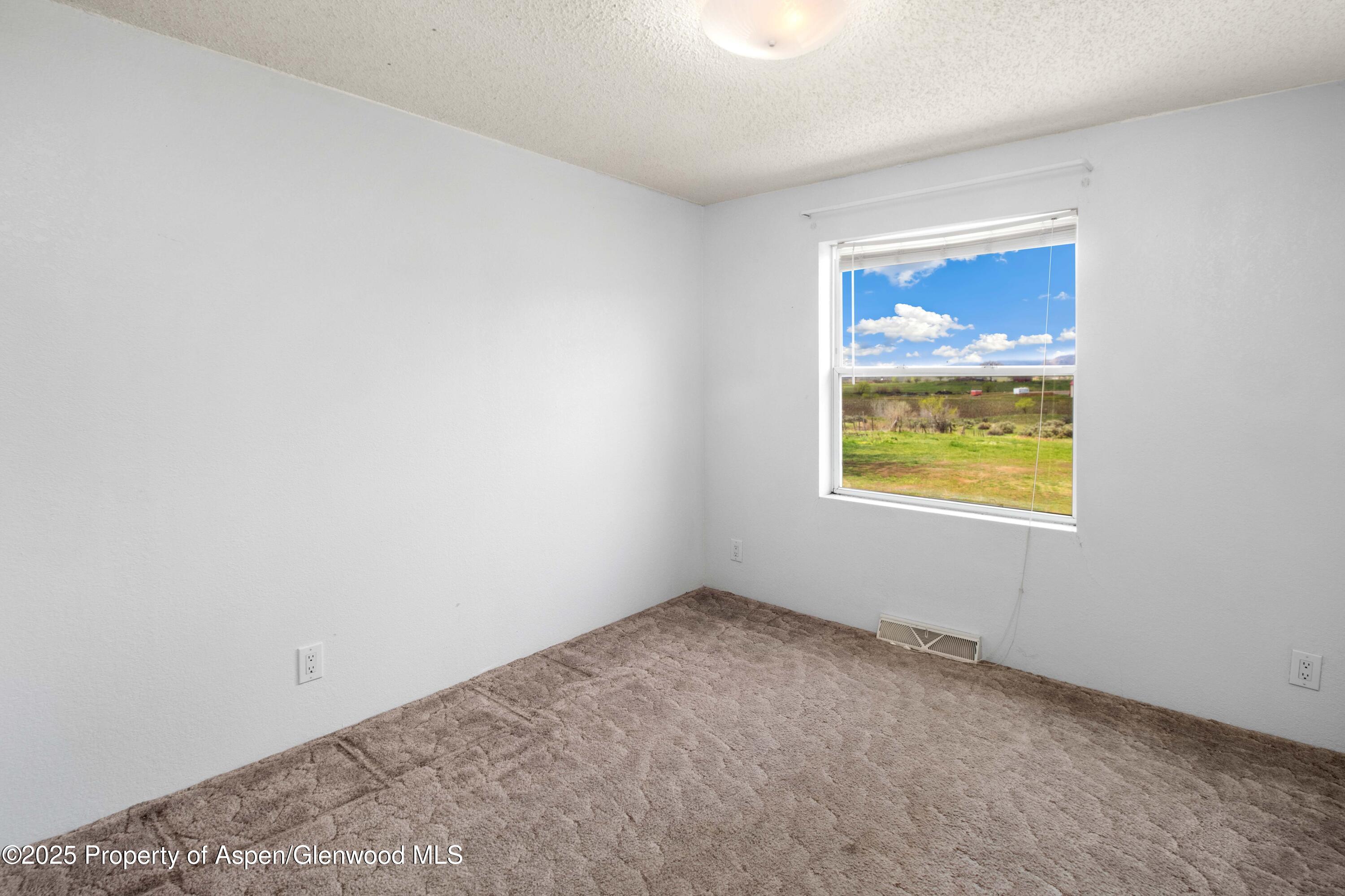 233 County Road 265 Rifle, CO 81650 - Photo 27 of 35 an empty room with windows