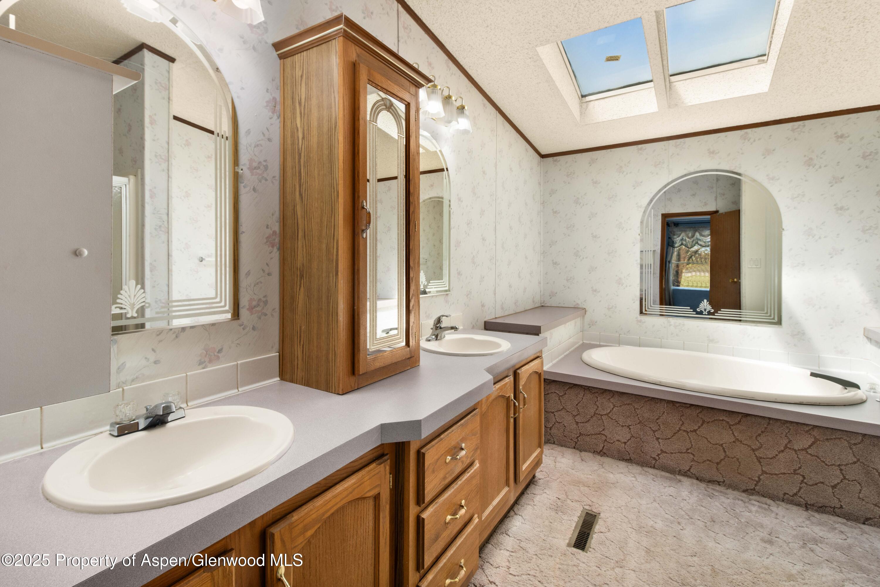 233 County Road 265 Rifle, CO 81650 - Photo 30 of 35 a bathroom with a granite countertop sink mirror and a bathtub