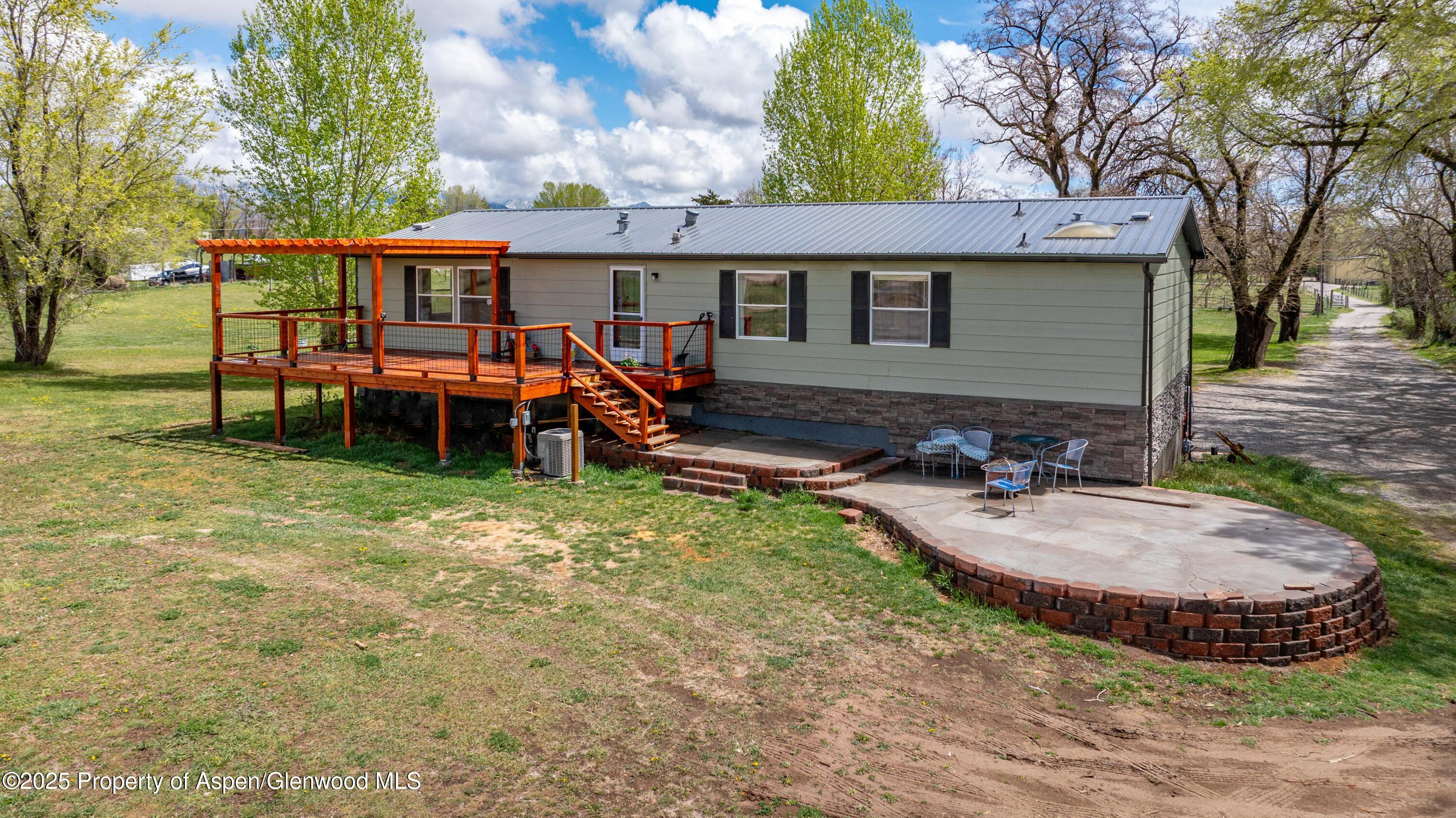233 County Road 265 Rifle, CO 81650 - Photo 3 of 35 a view of a house with backyard and sitting area