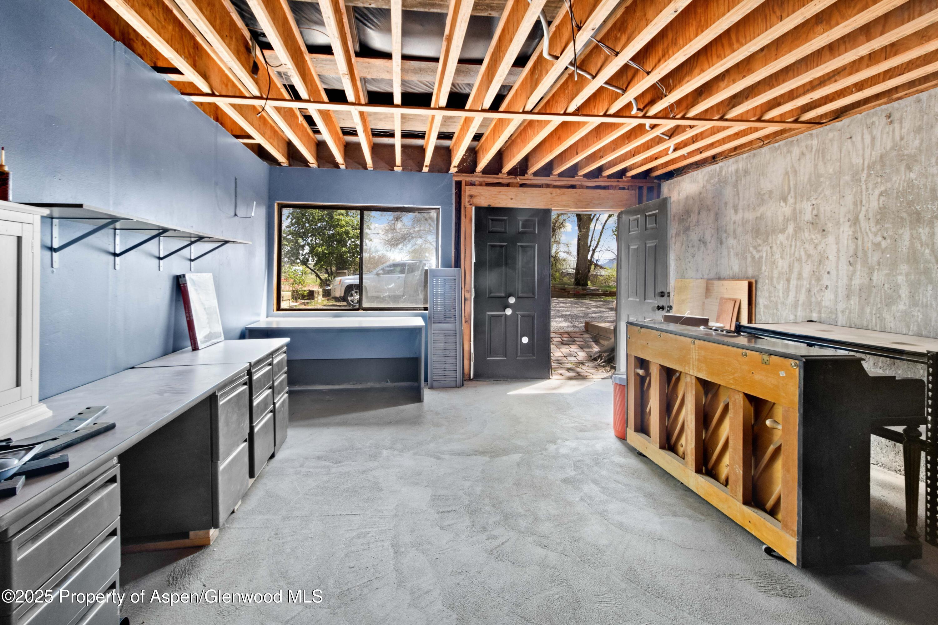 233 County Road 265 Rifle, CO 81650 - Photo 34 of 35 a large kitchen with stainless steel appliances wooden cabinets a sink and a counter top