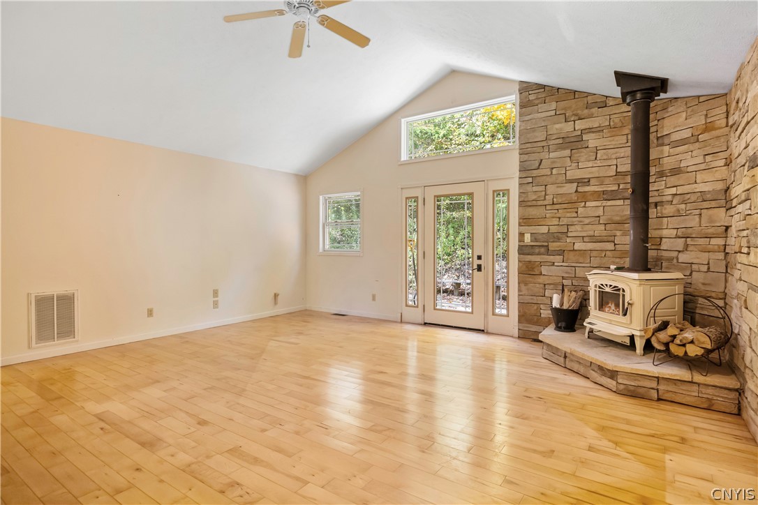 3985 Williams Corners Road Eaton, NY 13408 - Photo 12 of 48 Living room has lots of light and a wood burning stove for extra warmth and ambiance.