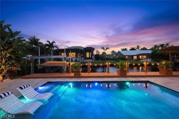 swimming pool view with a lake view