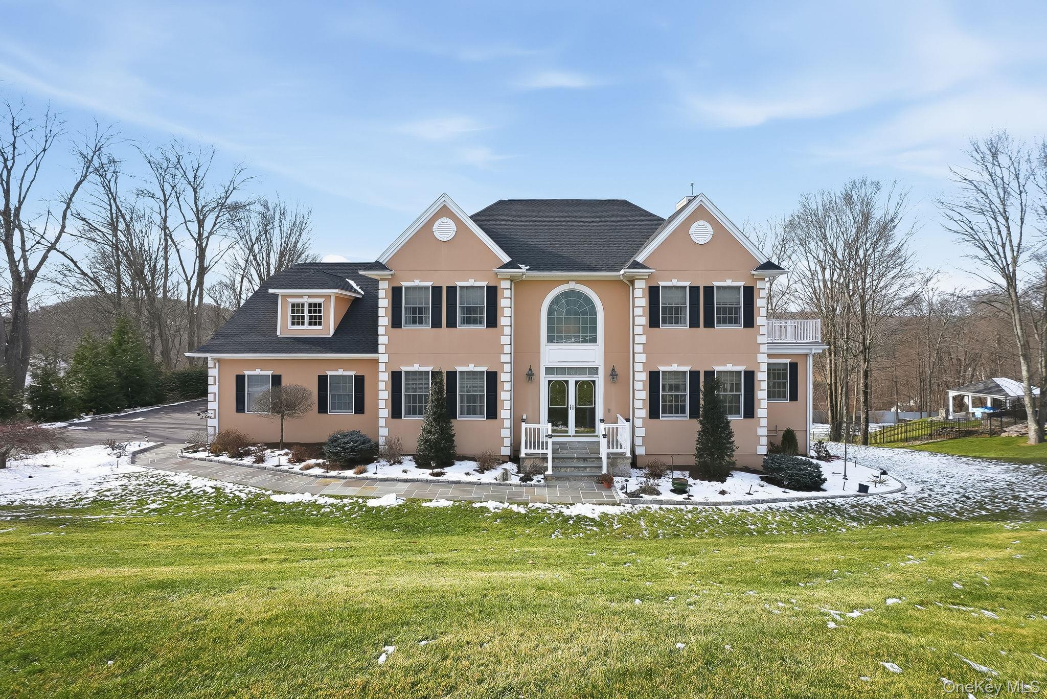 a front view of a house with yard swimming pool and outdoor seating
