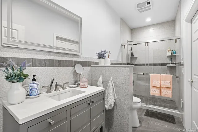 a bathroom with a sink toilet and shower