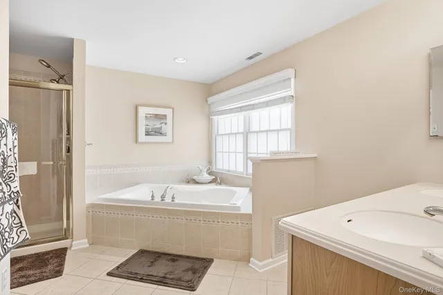 a bathroom with a sink a bathtub and a shower