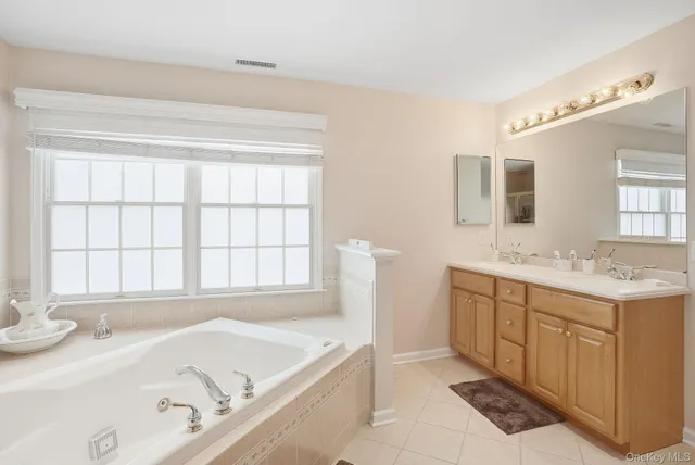 a spacious bathroom with a sink and a bathtub