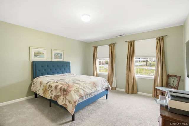 a bedroom with a bed and a dresser in it