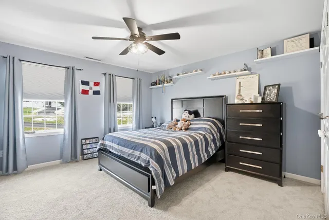 a bed room with a bed and a ceiling fan