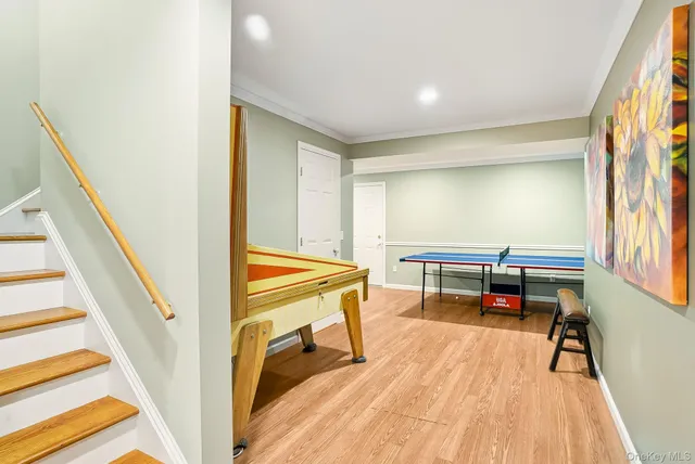 a reading room with wooden floor and furniture