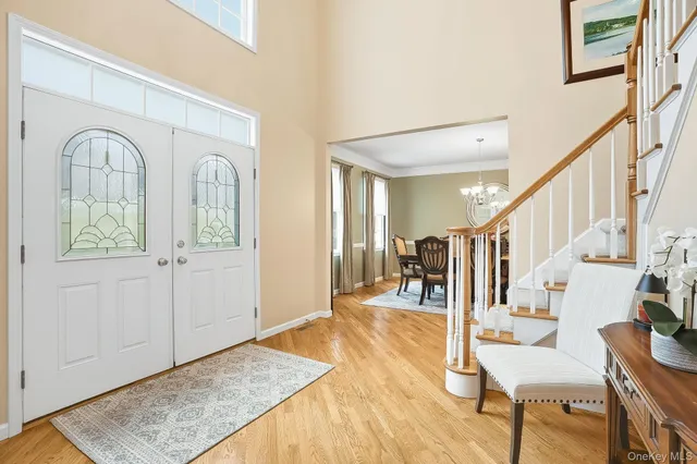 a view of entryway and hall with wooden floor