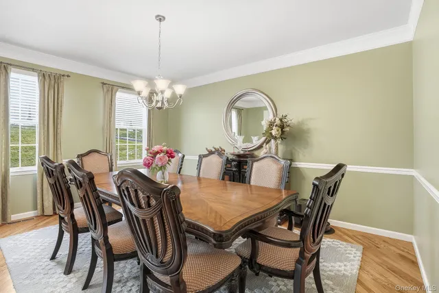 a view of a dining room with furniture and chandelier
