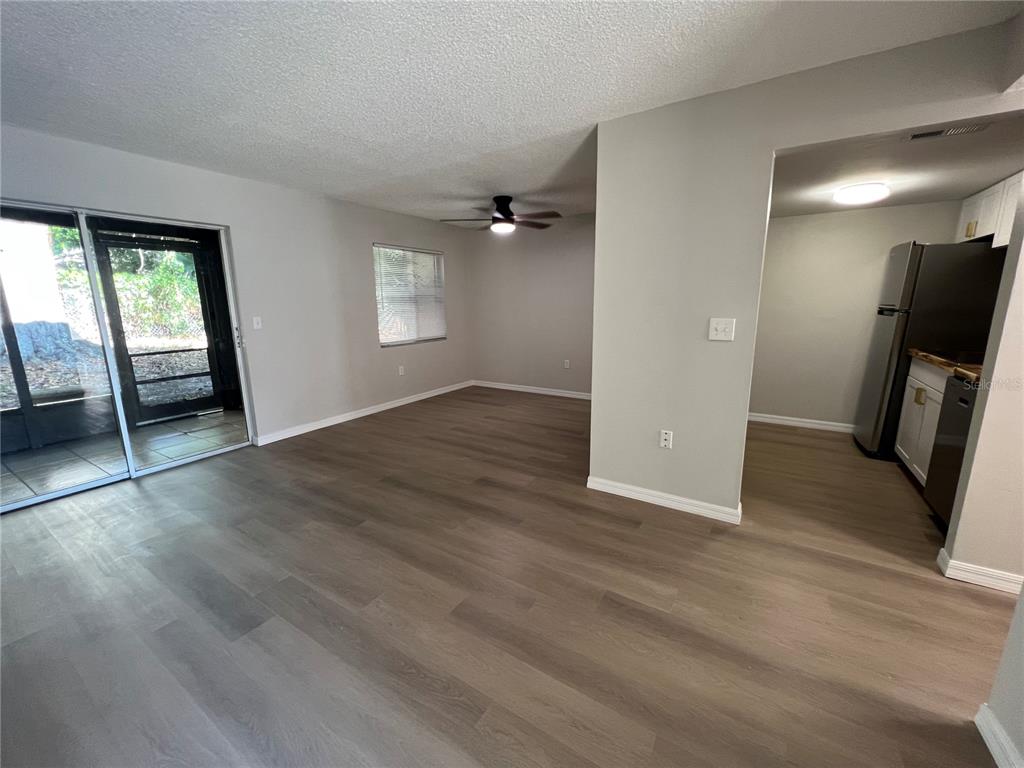 2611 Pine Lake Terrace, Unit B Sarasota, FL 34237 - Photo 2 of 21 an empty room with wooden floor and windows