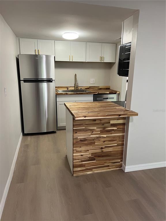 2611 Pine Lake Terrace, Unit B Sarasota, FL 34237 - Photo 6 of 21 a view of kitchen with stainless steel appliances a refrigerator and a stove top oven