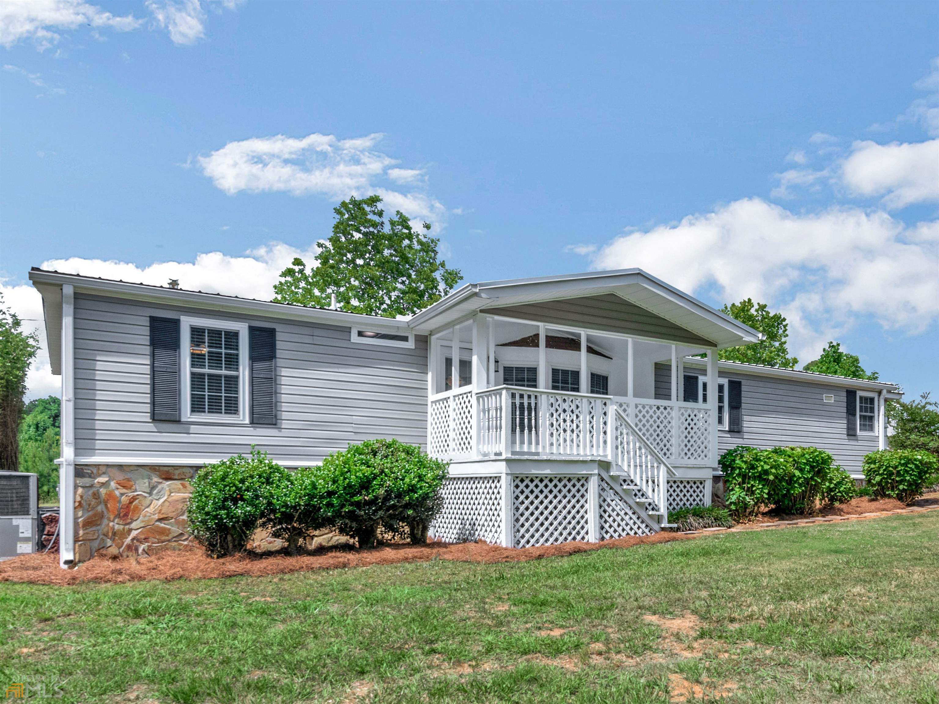 194 Hendricks Road Milner, GA 30257 - Photo 1 of 1 a front view of a house with a yard and potted plants