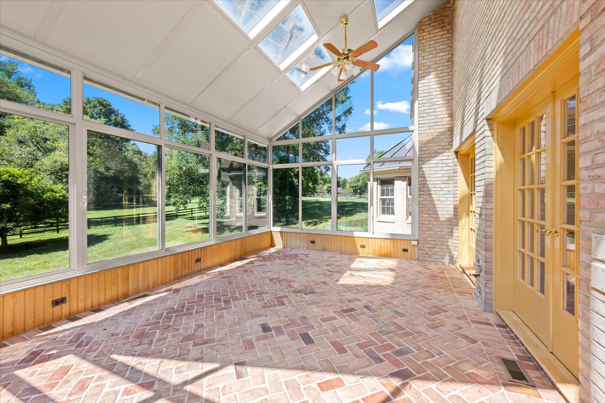1051 Kelso Road Great Falls, VA 22066 - Photo 14 of 40 Stunning, light-flooded sunroom with lovely views
