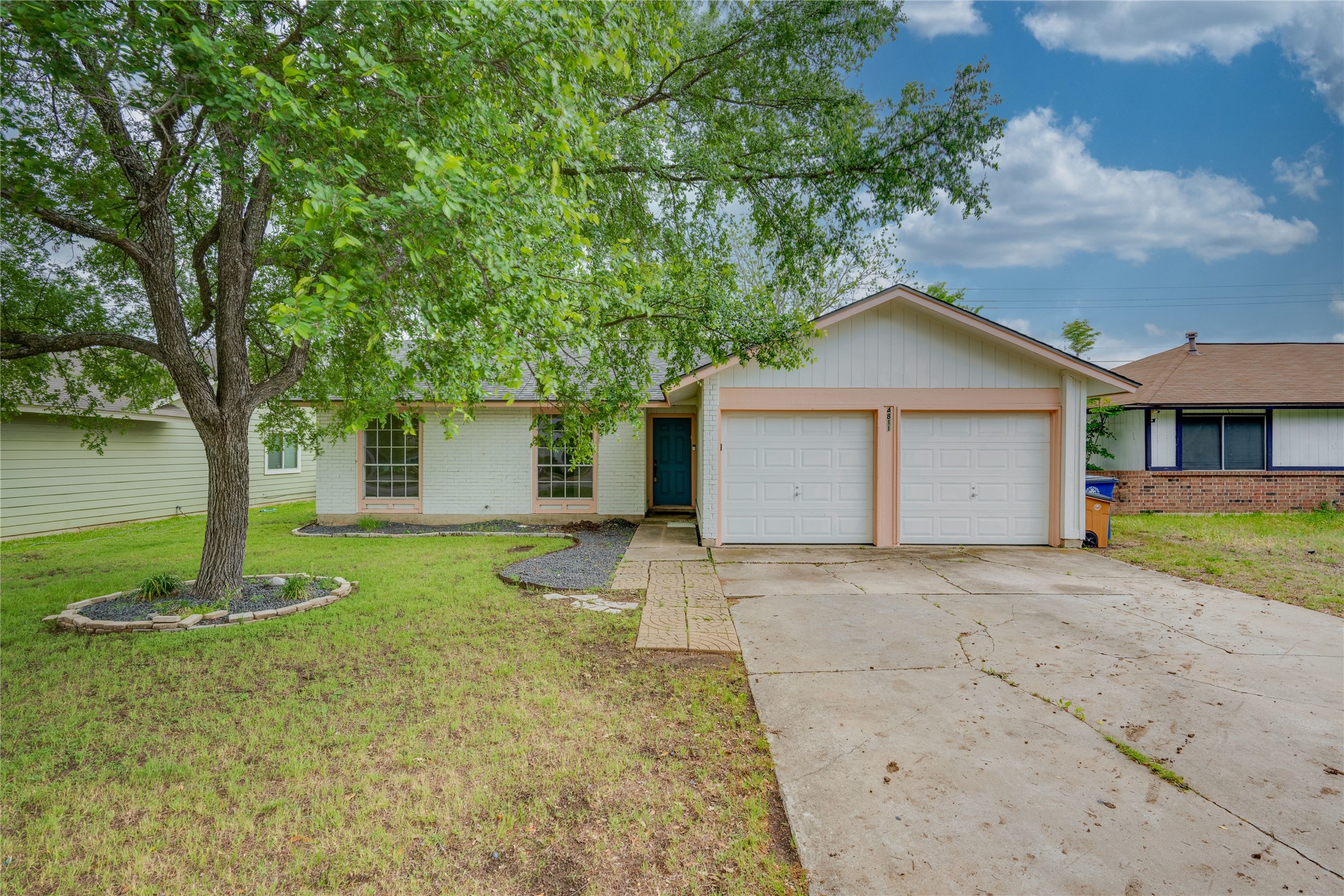 4811 Brushy Ridge Drive Austin, TX 78744 - Photo 1 of 39 Ranch-style home featuring driveway, a garage, a front lawn, and brick siding