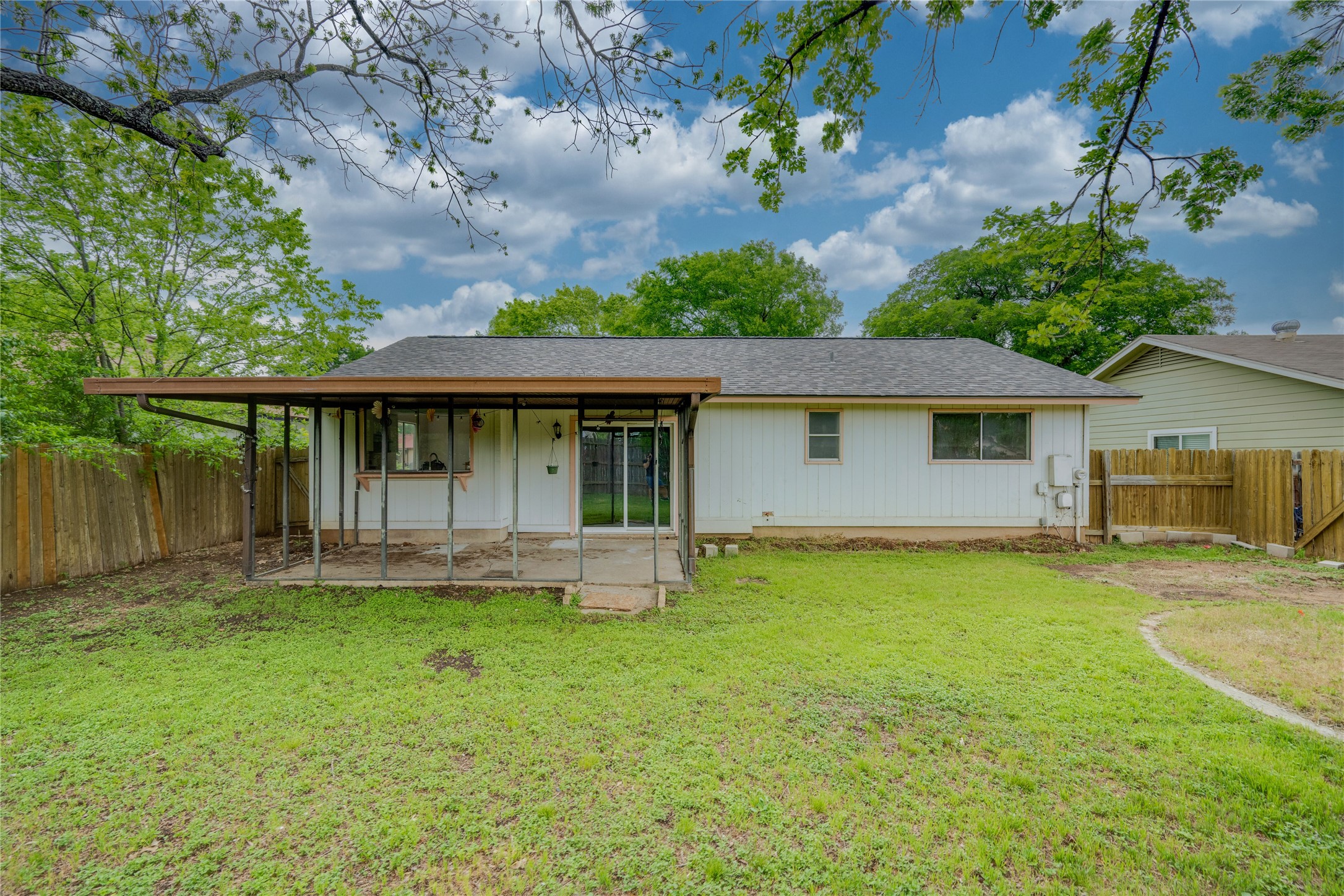 4811 Brushy Ridge Drive Austin, TX 78744 - Photo 11 of 39 Rear view of house with a fenced backyard and roof with shingles