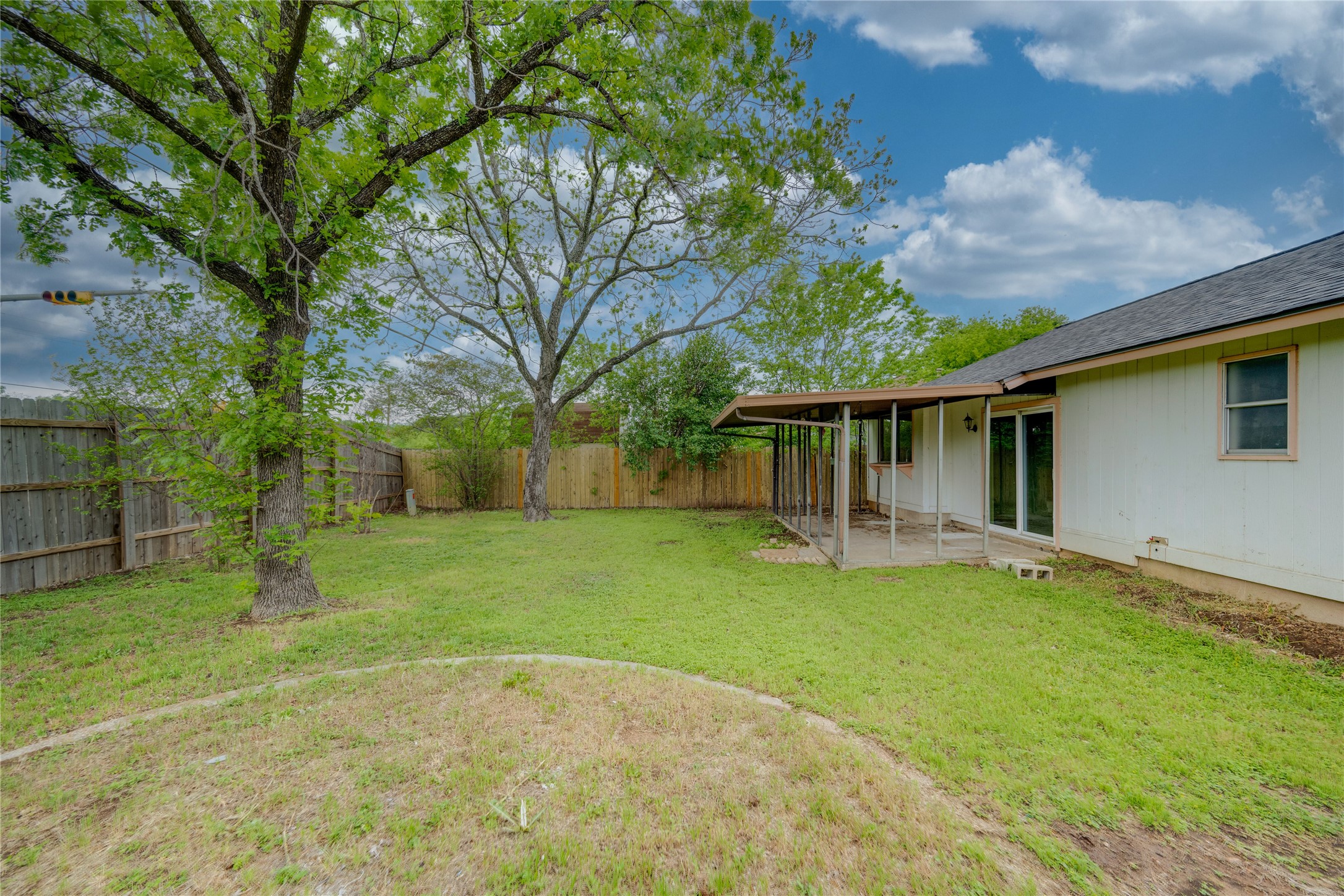 4811 Brushy Ridge Drive Austin, TX 78744 - Photo 14 of 39 Fenced backyard with a patio area