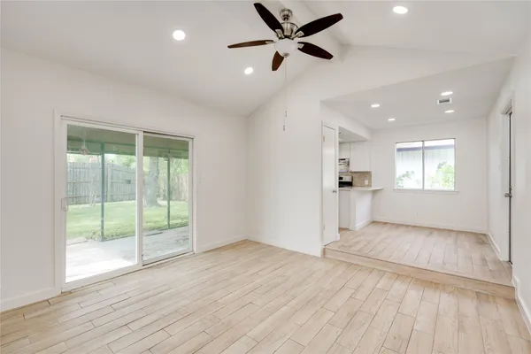 a view of a livingroom with a ceiling fan and window