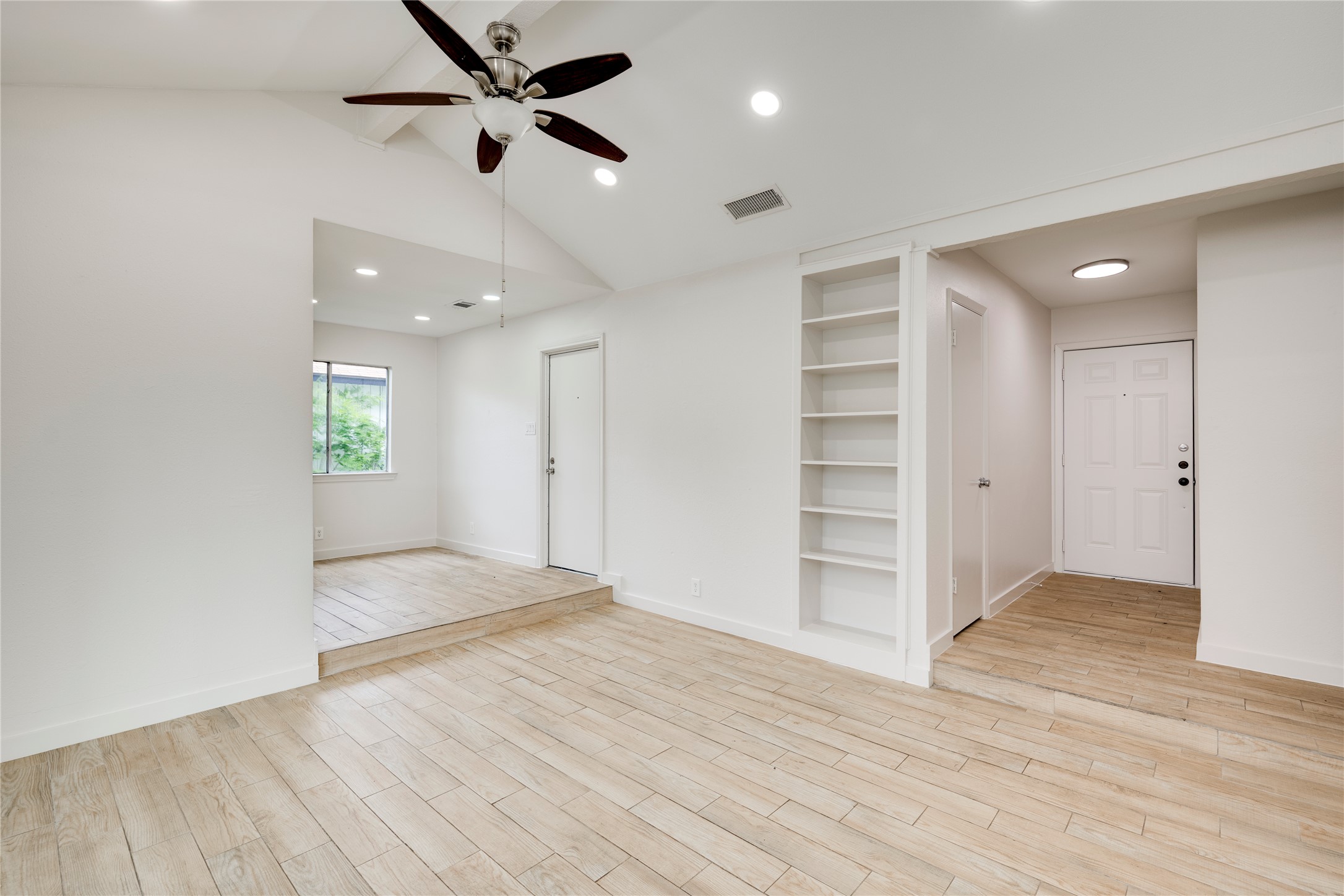 4811 Brushy Ridge Drive Austin, TX 78744 - Photo 18 of 39 Spare room featuring built in features, light wood finished floors, ceiling fan, and recessed lighting