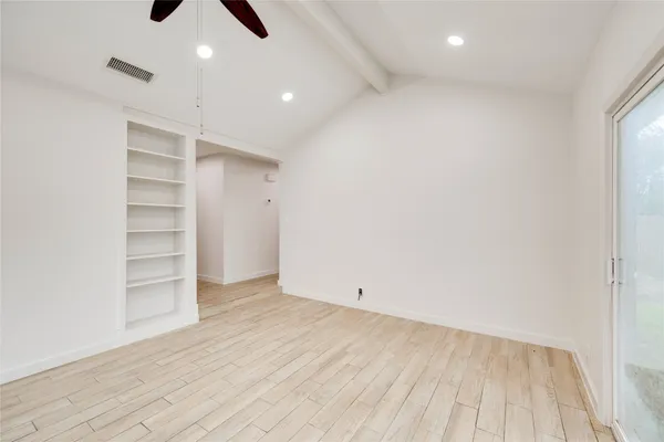wooden floor in an empty room with a window