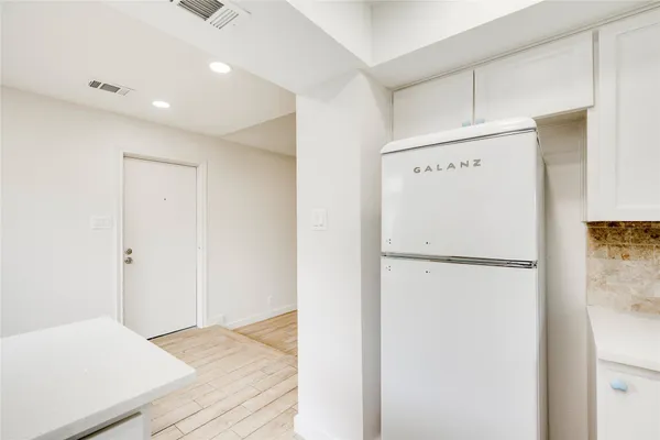 a white refrigerator freezer sitting in a kitchen