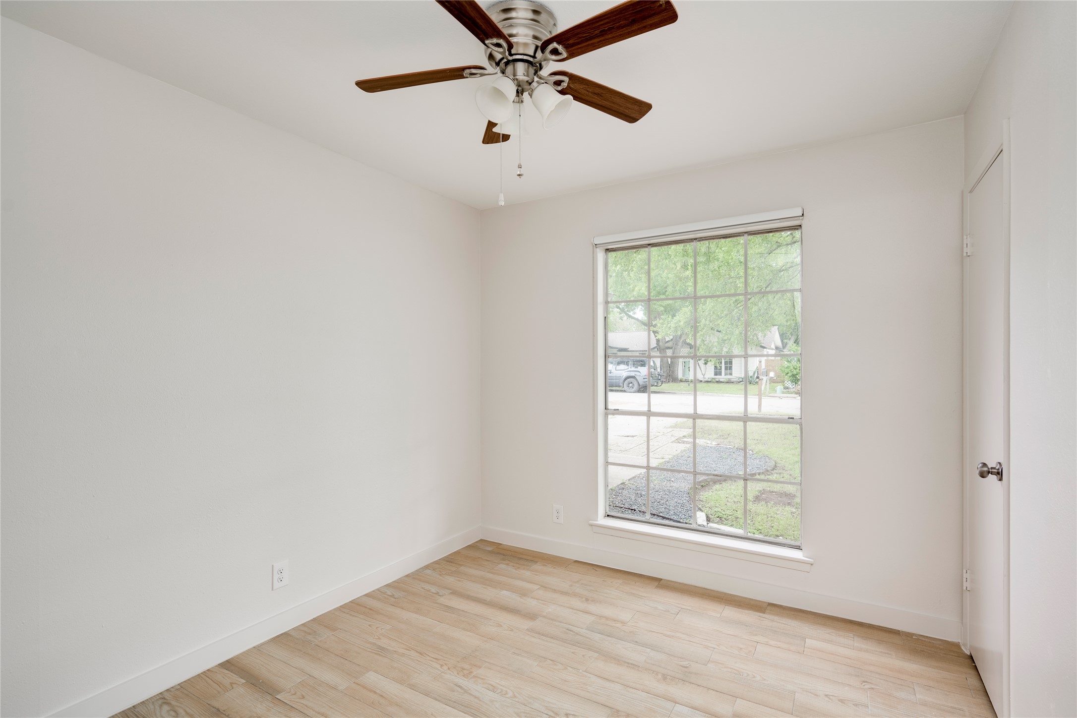 4811 Brushy Ridge Drive Austin, TX 78744 - Photo 29 of 39 Spare room featuring light wood-style flooring and ceiling fan