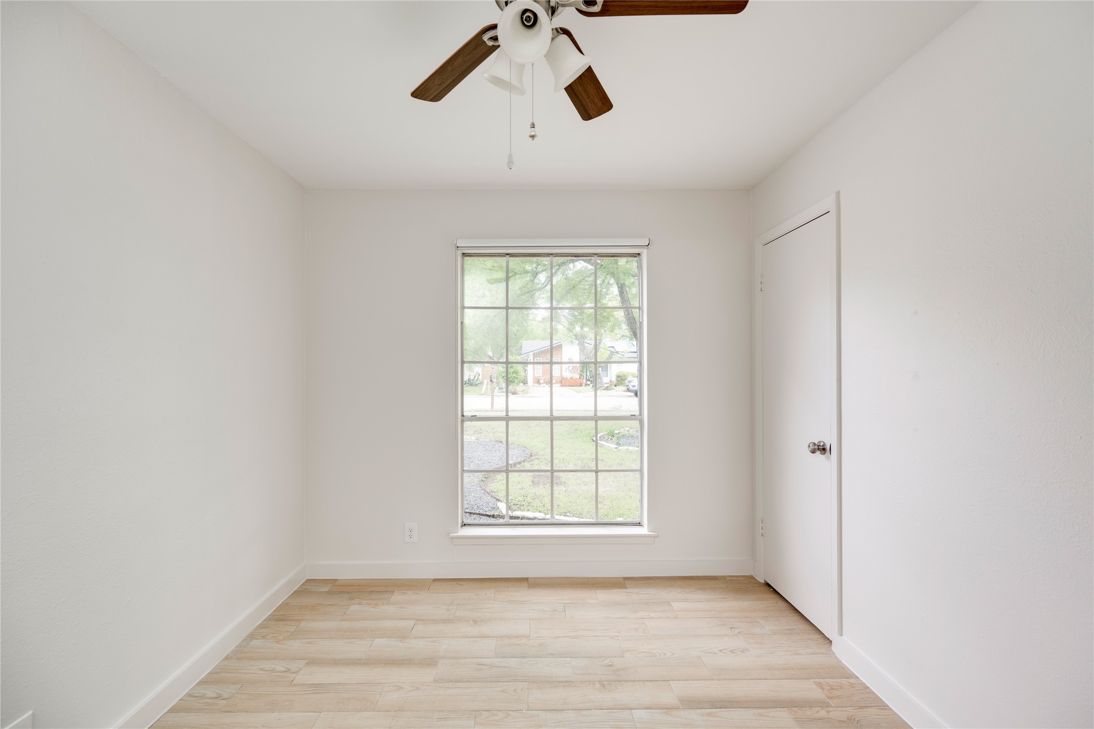 4811 Brushy Ridge Drive Austin, TX 78744 - Photo 31 of 39 Unfurnished room with light wood-style floors and a ceiling fan
