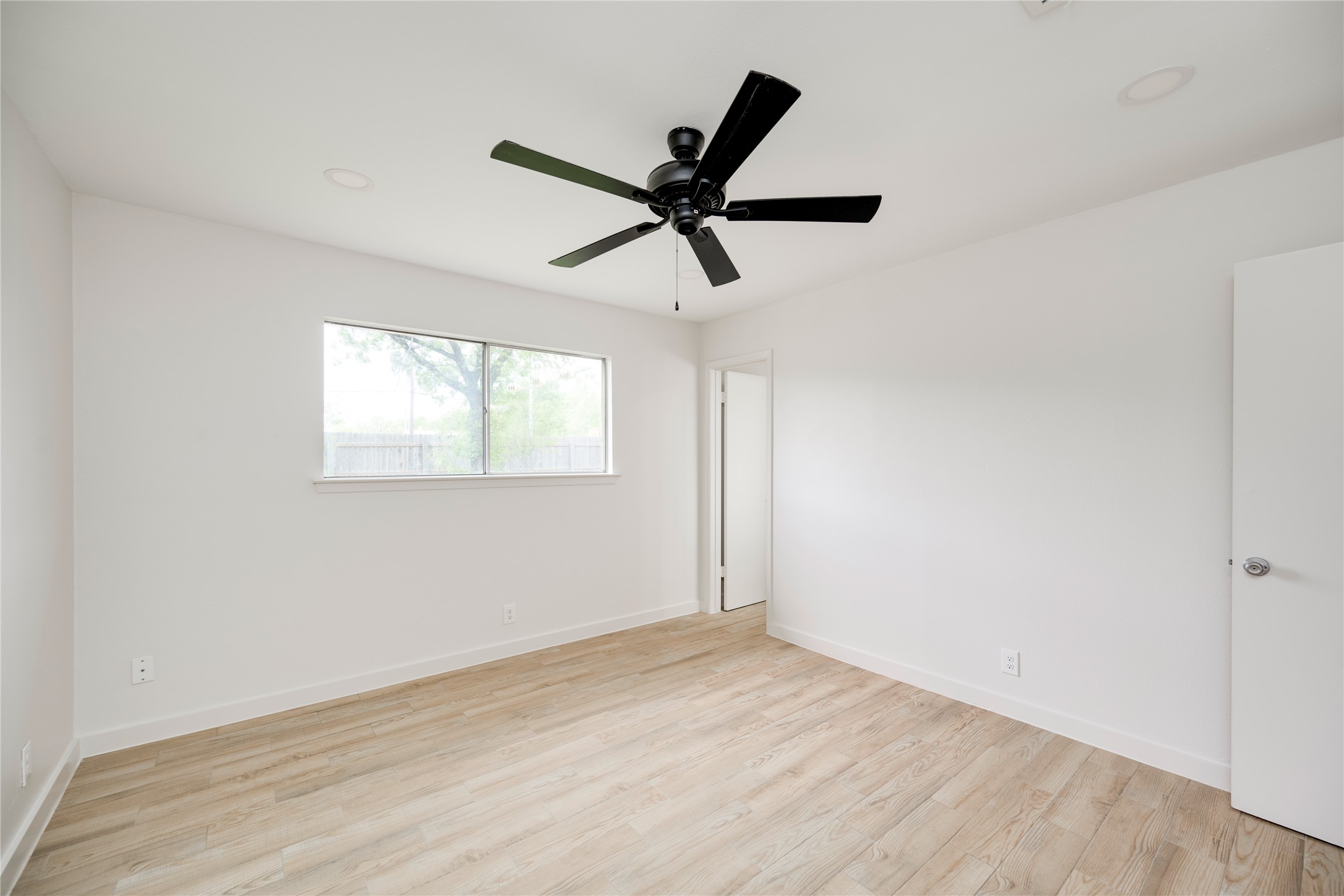 4811 Brushy Ridge Drive Austin, TX 78744 - Photo 36 of 39 Empty room with light wood-style floors, recessed lighting, and ceiling fan