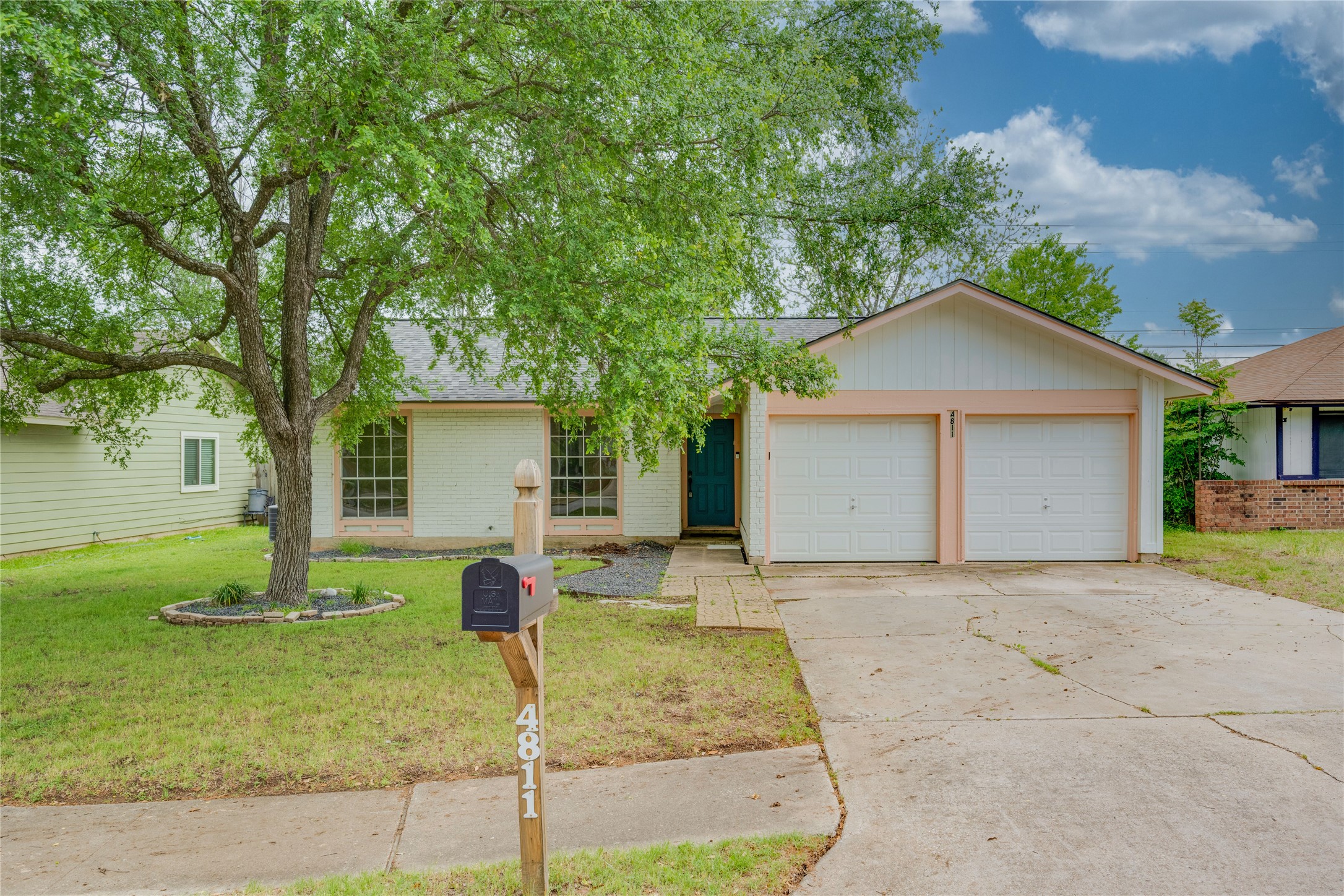 4811 Brushy Ridge Drive Austin, TX 78744 - Photo 6 of 39 Ranch-style home with an attached garage, concrete driveway, a front yard, and brick siding
