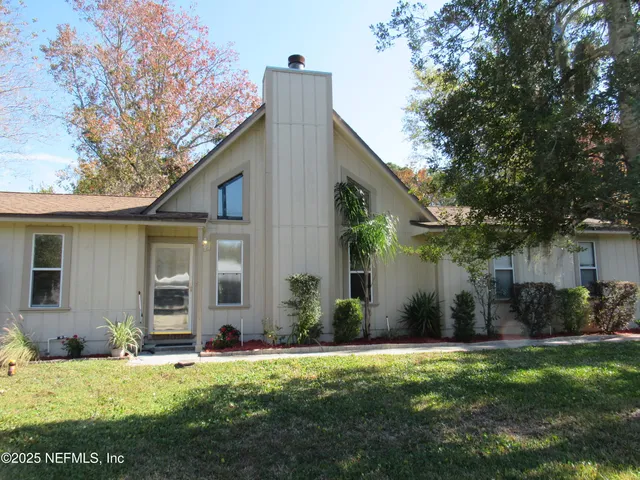a front view of house with yard and green space