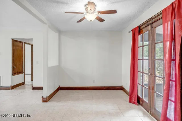 a view of a livingroom with a ceiling fan and window