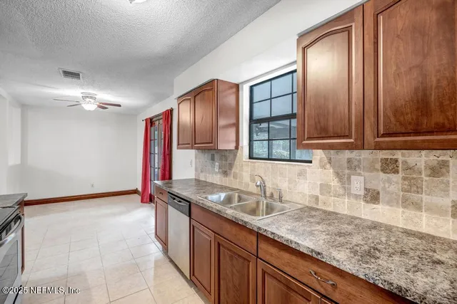 a kitchen with stainless steel appliances granite countertop a sink and cabinets