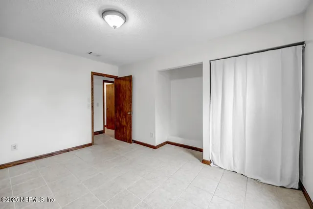 a bathroom with a granite countertop sink a toilet and a bathtub