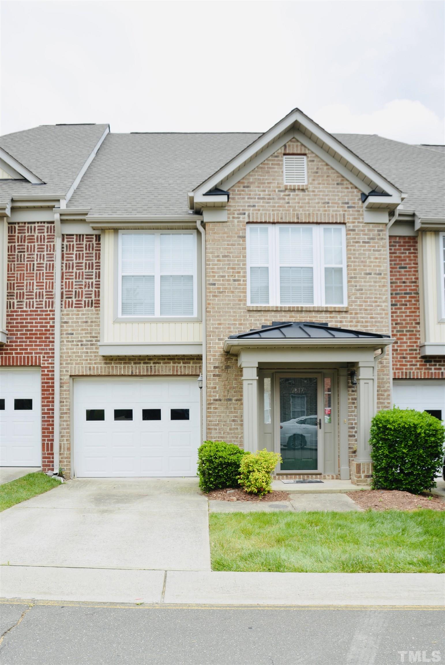 9817 Grettle Court Raleigh, NC 27617 - Photo 1 of 15 a front view of a house with a yard and garage