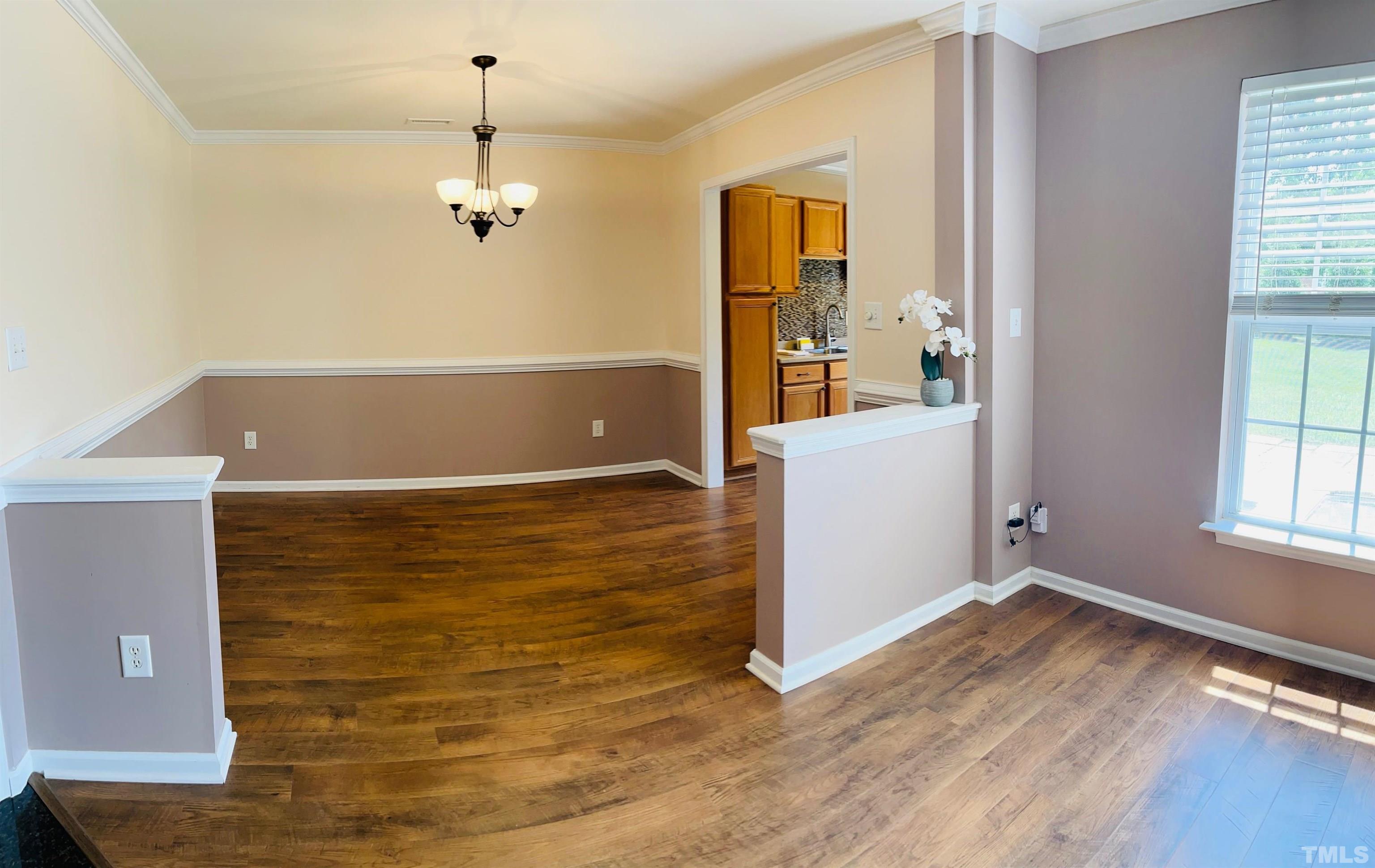 9817 Grettle Court Raleigh, NC 27617 - Photo 14 of 15 wooden floor in an empty room with a window