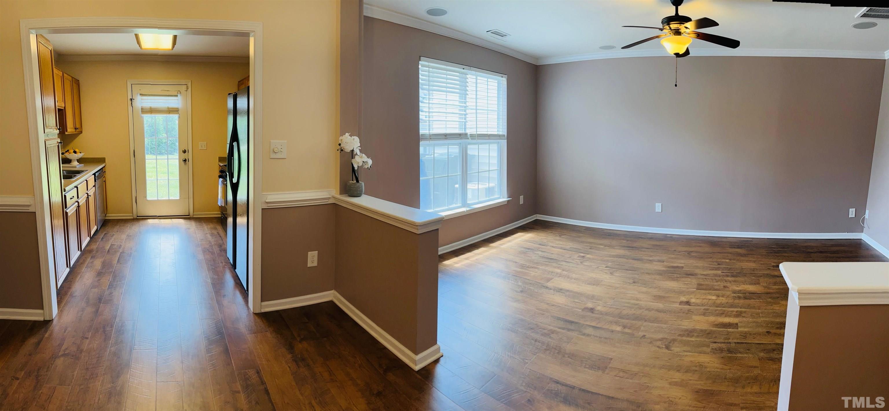 9817 Grettle Court Raleigh, NC 27617 - Photo 5 of 15 wooden floor in an empty room with a window