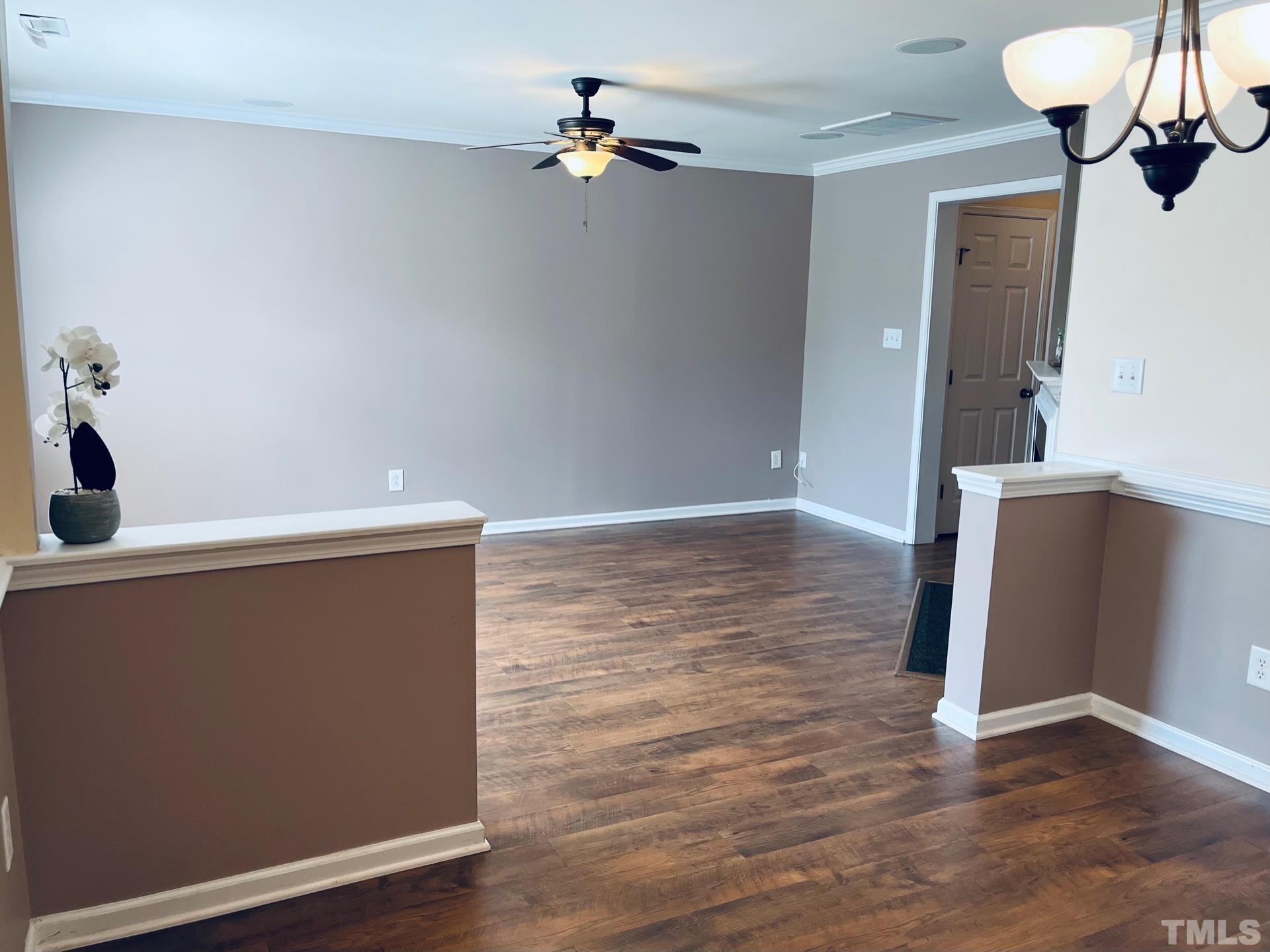 9817 Grettle Court Raleigh, NC 27617 - Photo 8 of 15 a view of room with hardwood floor and ceiling fan