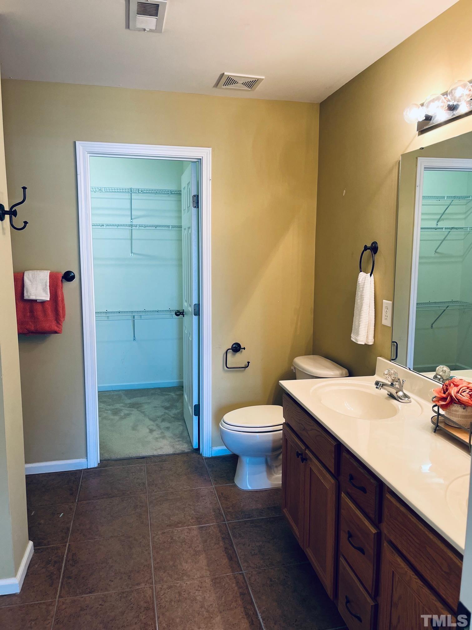 9817 Grettle Court Raleigh, NC 27617 - Photo 10 of 15 a bathroom with a sink a toilet and shower