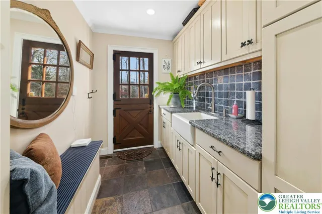 a kitchen with granite countertop cabinets a sink and a window