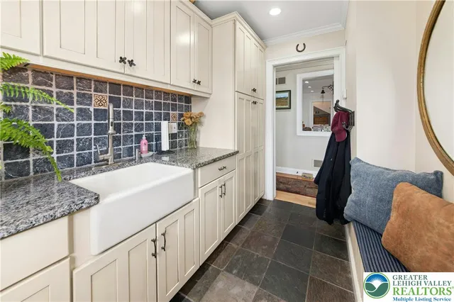 a spacious bathroom with a granite countertop sink a mirror and shower