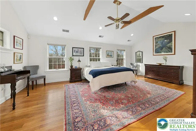 a spacious bedroom with a bed a window and a couch