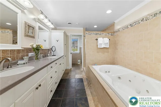 a bathroom with a double vanity sink and mirror with shower