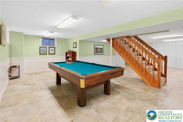 a living room with stairs and a table